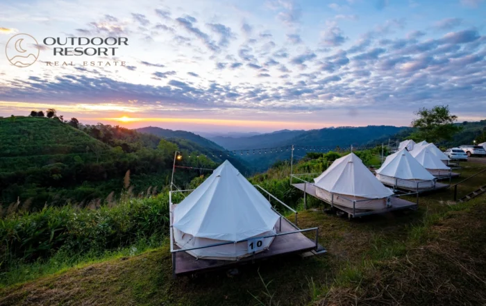 Glamping real estate with luxury outdoor tents overlooking a scenic mountain resort