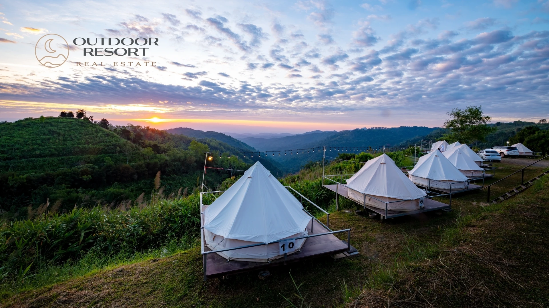 Glamping real estate with luxury outdoor tents overlooking a scenic mountain resort