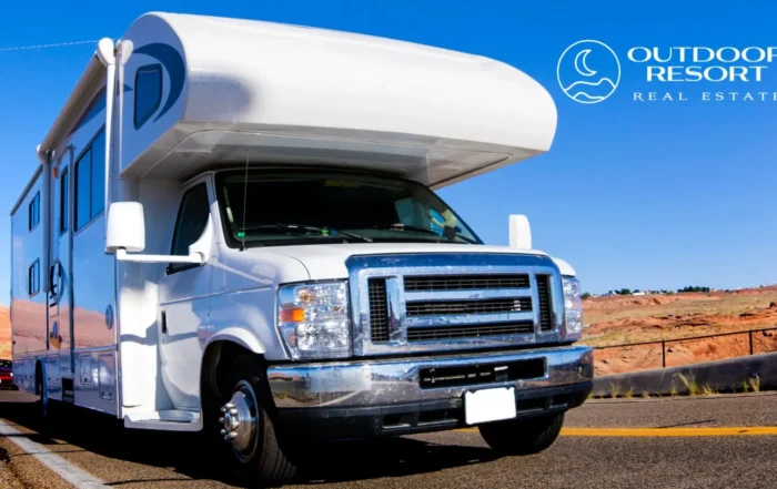 Buying a resort lot before the new year for tax savings, with a motorhome on a desert highway