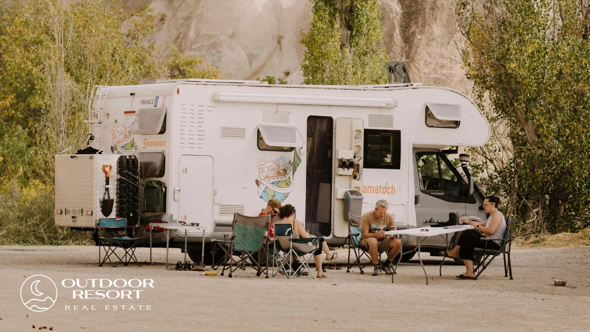Sunbelt resort lot in autumn, with a motorhome and travelers relaxing at an outdoor RV resort