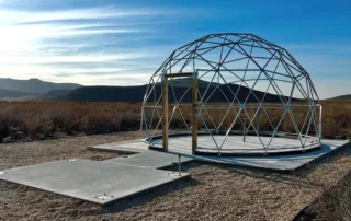 Geodesic dome frame on a concrete pad for glamping expansion at Glamp the World in Clint, TX