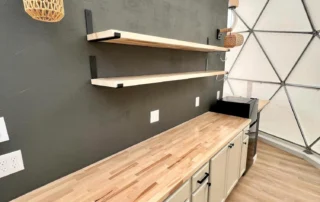 Glamping dome kitchenette with wood counters and floating shelves, Clint, TX glamping property for sale