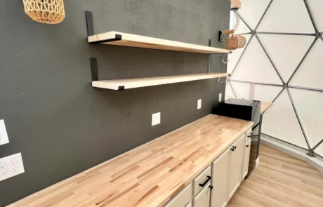 Glamping dome kitchenette with wood counters and floating shelves, Clint, TX glamping property for sale